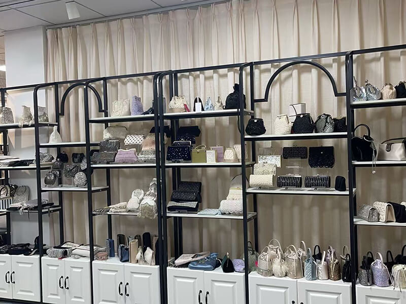 Exhibition hall displaying a wide range of evening clutches and handbags on multi-tier shelves